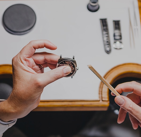 Hands of an expert craftsman working on a watch